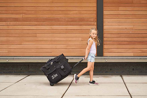 Young Dancer Pulling her Dance Duffel